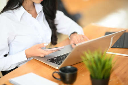 Close up woman typing laptop computer with empty screen.の写真素材