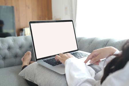 Young business woman using laptop with white screenの写真素材