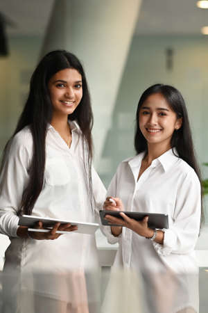 Young professional graphic designer team discussing the concepts together using laptop and tablet in office.の写真素材