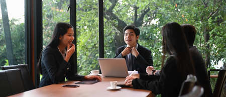 Business professionals working together in meeting room at office.