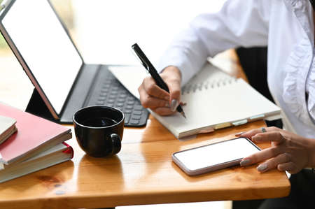 A young businesswoman planing her project on notebook at work spcae.