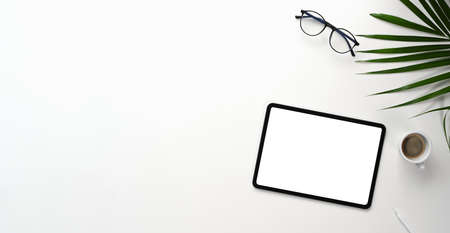 Top view of simple workplace with blank screen smart phone, glasses and coffee cup on wooden table.