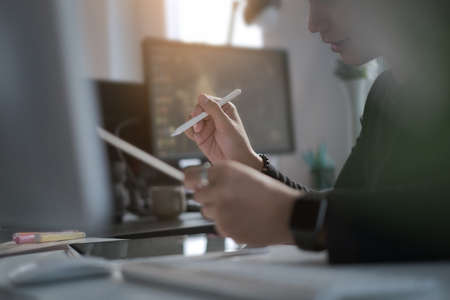 Cropped shot of Illustrator Graphic designer working with digital tablet and computer at his...