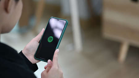 CHIANGMAI, THAILAND, Oct 22, 2020: Woman holding a Phone 11 Pro max opening spotify app, Spotify is...