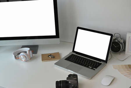 Creative designer workspace with  with empty screen laptop, computer, camera and essential elements.の写真素材