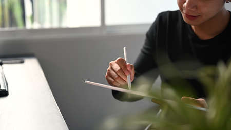 Cropped shot of graphic designer or photographer hand drawing at portable tablet computer.の写真素材