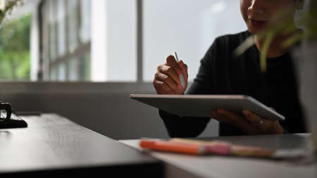 Portrait of graphic designer or photographer is using digitizer and colour sample in his office.の写真素材