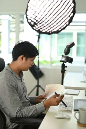 Side view of graphic designer or photographer is working with color samples for selection.の写真素材