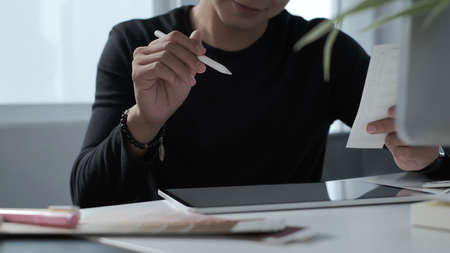 A professional investor man is working with new startup project on laptop at modern office.の写真素材