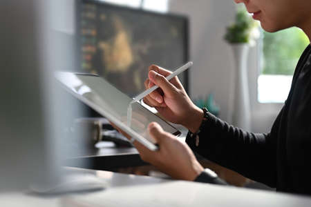 Cropped shot of man secretary checking mail on netbook organizing working process in officeの写真素材