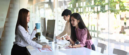 Group of asian ui ux designers are working and designing  together a user interface for website and application.の写真素材