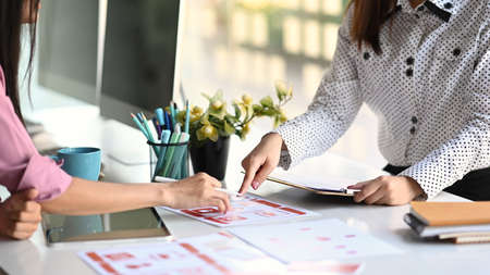 Group of asian ui/ux developer are brainstorming about mobile app interface wireframe design on...