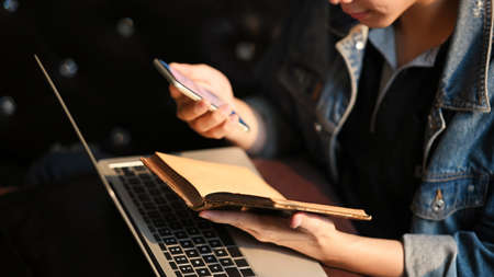 Cropped shot young businessman using laptop for planning his strategyのeditorial素材