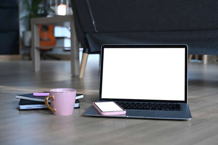 Close up view of female holding mobile phone with blank screen in her workplace. Blank screen for...