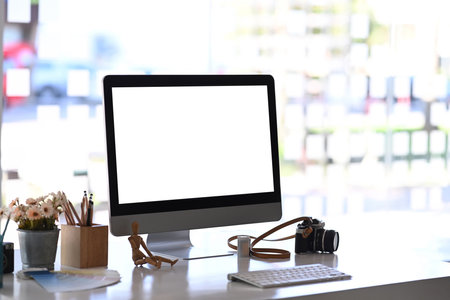 Side view of graphic designer working with stylus pen and computer tablet at her creative  workspace.の写真素材