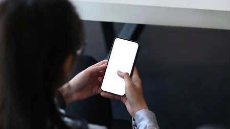 Close up view of young female designer hands typing on keyboard of mock up computer tablet at creative workspace.の写真素材