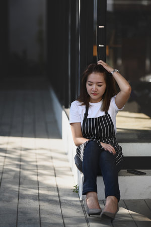 Portrait of startup small business entrepreneur woman feeling stressed because of economic conditions.の写真素材