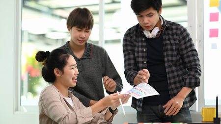 Group of creative designer people discussing new project plan in modern office.の写真素材