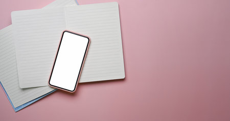 Flat lay women office desk with notebook coffee cup,pink bouquet and stationery on pastel pink background.の写真素材