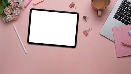 Overhead shot of woman holding box with fresh strawberry on pastel pink background.の写真素材