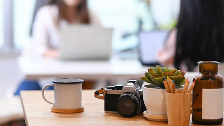 Horizontal image of workspace with laptop, notebook and coffee cup on wooden desk. Copy space for your text or advertising content.の写真素材