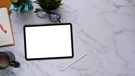 Close up view of young man hands holding mobile phone with blank screen while sitting on wooden...
