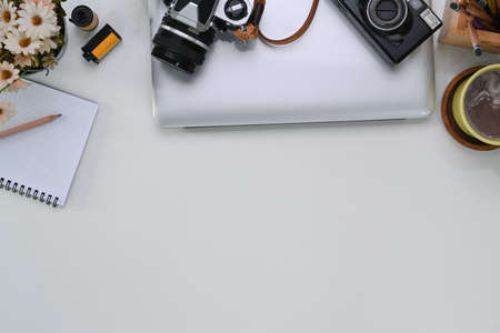 Close up view of young man hands holding mobile phone with blank screen while sitting on wooden floor.の写真素材