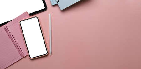 Cropped shot of young school girl studying online with laptop computer and using mobile phone searching information.の写真素材