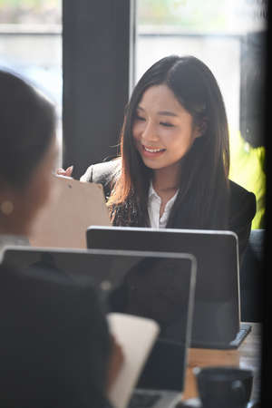 Two businesswoman working planning with colleague in modern office.