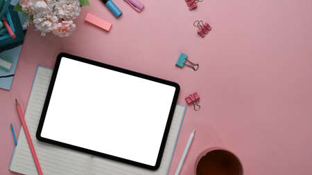 Above view of modern feminine  workspace with digital tablet, stylus pen, stationery, notebook and...