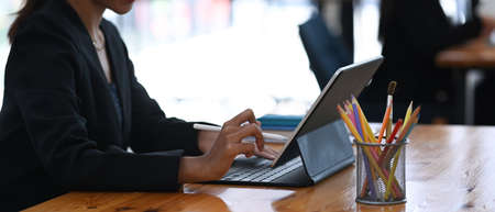 Young asian businesswoman working on her project with laptop computer while sitting a office desk.の写真素材