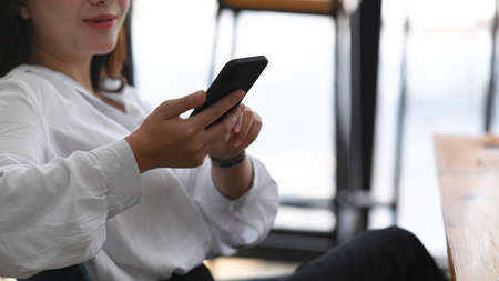 Confident businesswoman showing digital tablet while sitting in office. Blank screen for your...