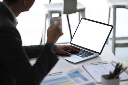 Businesspeople using digital tablet and discussing company business at modern office.の写真素材