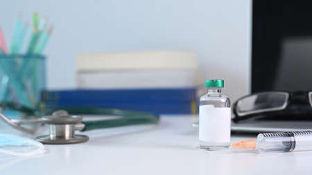Simple workplace with computer laptop, coffee cup, books and stationery on white table.の写真素材