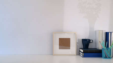Empty notebook, pencil, coffee cup, plant and copy space on white office desk.の写真素材