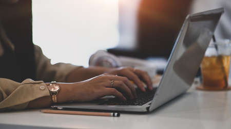 Flat lay photo of designer workspace with notebook, coffee cup and wireless keyboard on two tone...