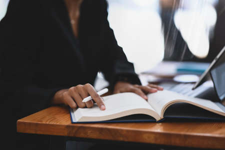 Cropped shot of male photographer putting digital camera into big bag with other gadgets.の写真素材