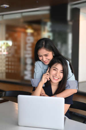 Two businesswoman colleagues discussing about new project plan at work at modern workplace.の写真素材