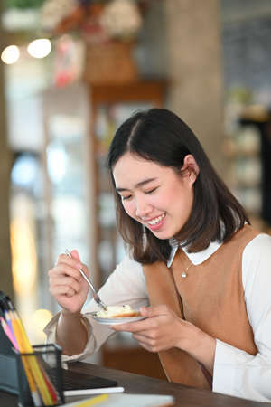 Silhouette of businesswoman sitting in office and holding digital tablet.の写真素材