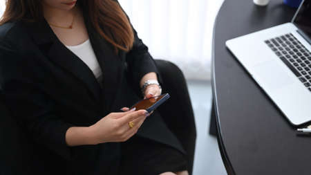 Portrait of focused young businesswoman looking at screen of computer laptop and feeling tired after unproductive work.の写真素材