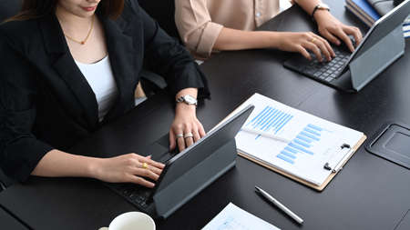 Portrait of focused young businesswoman looking at screen of computer laptop and feeling tired after unproductive work.の写真素材