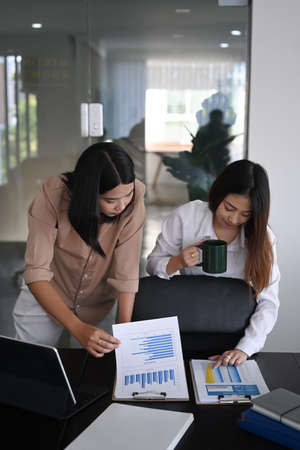 Two businesswoman working with business documents and discussing new project in office.の写真素材