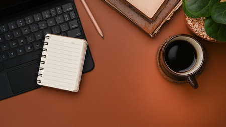 Top view of minimal workplace with digital tablet, smart phone, keyboard and coffee cup on white office desk.の写真素材
