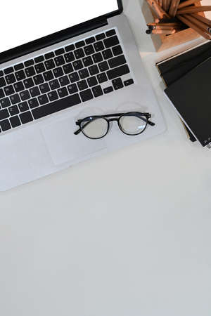 Overhead shot of vintage workplace with coffee cup, notebook, book and copy space brown leather.