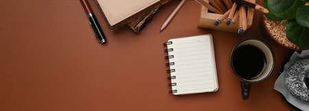 Front view of mock up computer with blank screen, house plant and office supplies on white office desk.の写真素材