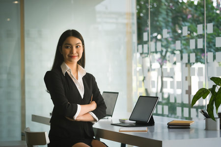Side view of businesswoman holding cup with hot coffee enjoying smell with close eyes in office.
