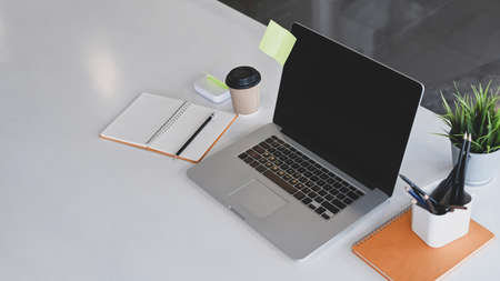 Mock up computer with blank screen at comfortable workplace.