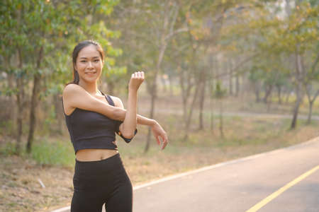 Portrait of sporty young woman running at the park in sunset.の写真素材