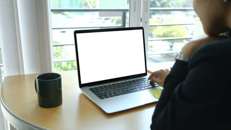 Portrait of businesswoman sitting with her colleague and working together on new project at modern...