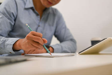 Frustrated businessman looking information on paperwork and crumpled paper.